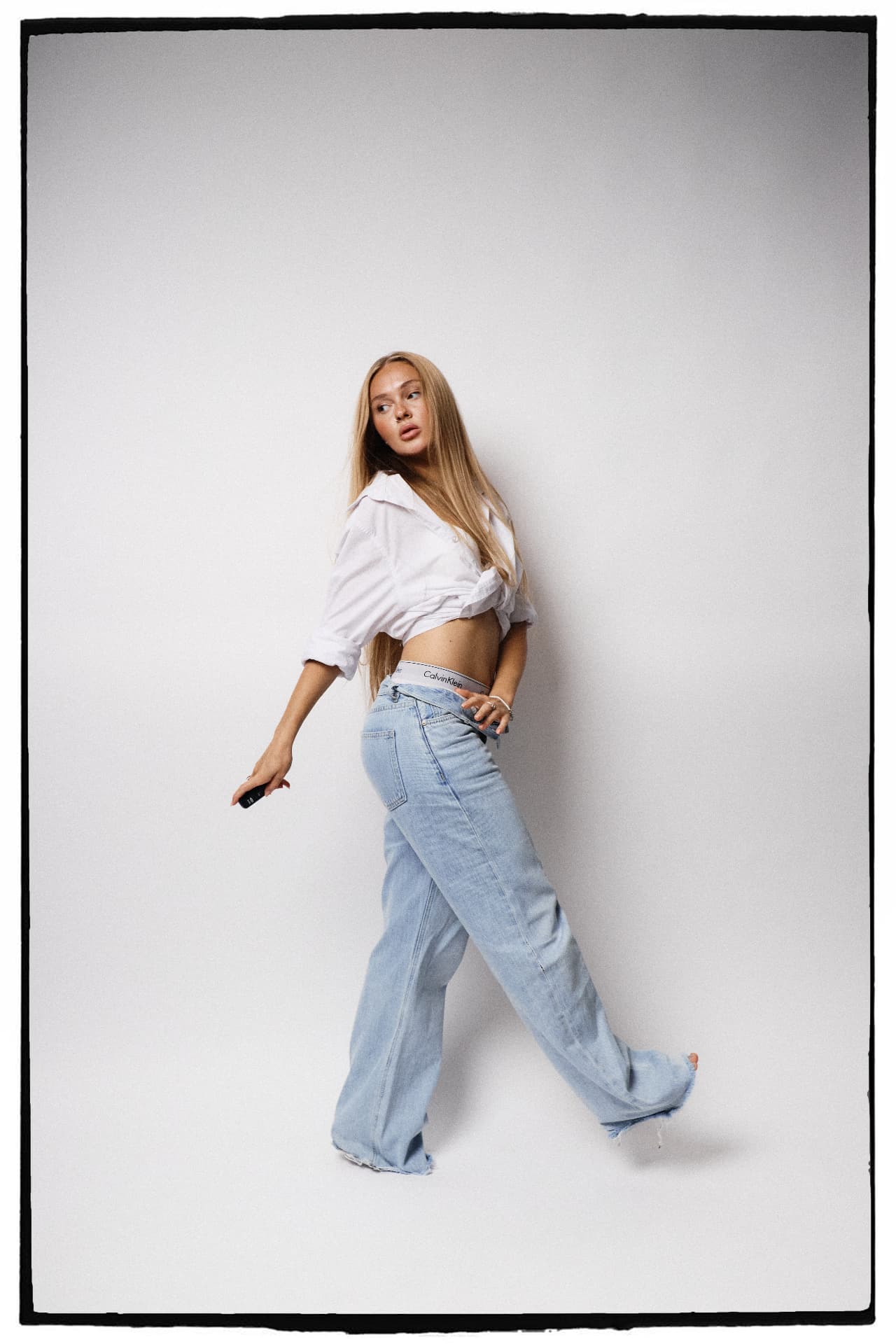 Blonde woman leaning against the wall